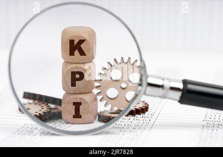 Business concept. There is a magnifying glass on the documents that points to the cubes with the inscription - KPI Stock Photo