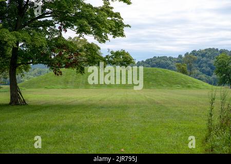 Large grass covered Native American prehistoric earthworks burial mound in Ohio Stock Photo