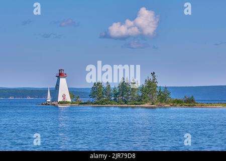 Baddeck is a village in Northwestern Nova Scotia situated on Bras d'Or lake and is a popular tourist destination.  The Kidston Island Lighthouse is lo Stock Photo