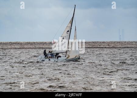 Russia, St. Petersburg, 29 July 2022: Small sport sailing yacht at stormy weather, roll of the boat, teamwork Stock Photo