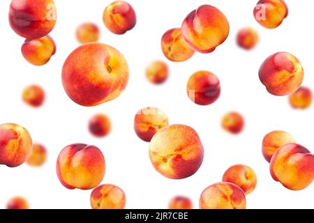 Falling Nectarine or peach isolated on white background, selective focus Stock Photo