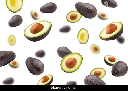 Falling avocado, isolated on white background, selective focus Stock Photo