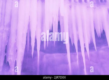 Ice and icicles on the rocks of Ogoy island, Baikal lake, Siberia, Russia. Toned in trendy color. Abstract winter nature background. Stock Photo