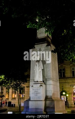 The Edith Cavell Memorial, a statue by Sir George Frampton, shot at dawn in 1915 in WWI, in the West End of London WC2, seen illuminated at night Stock Photo