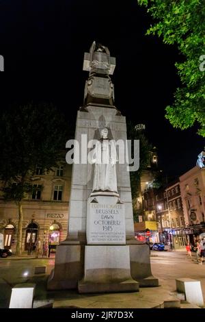 The Edith Cavell Memorial, a statue by Sir George Frampton, shot at dawn in 1915 in WWI, in the West End of London WC2, seen illuminated at night Stock Photo