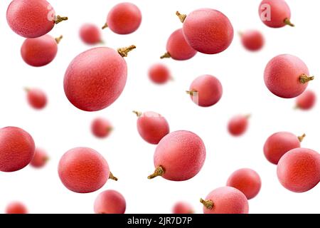 Falling red grape, isolated on white background, selective focus Stock Photo