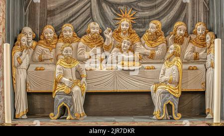 the disciples carved as golden figures sit at the table with Jesus at the Last Supper, Mariager, Denmark, August 7, 2022 Stock Photo