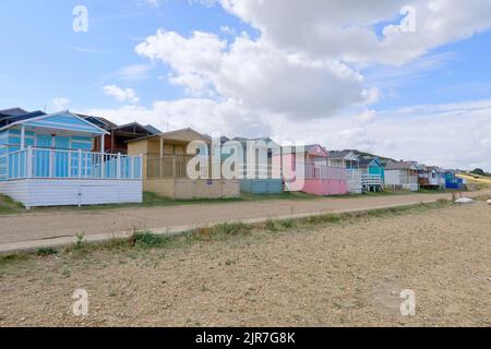 Colourful beach huts along the promenade at Tankerton Stock Photo