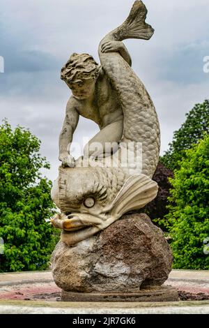 A vertical closeup shot of the Boy and Dolphin water fountain in Hyde Park, London, UK Stock Photo