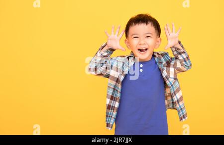 excited asian boy  gesturing actively with both hands Stock Photo