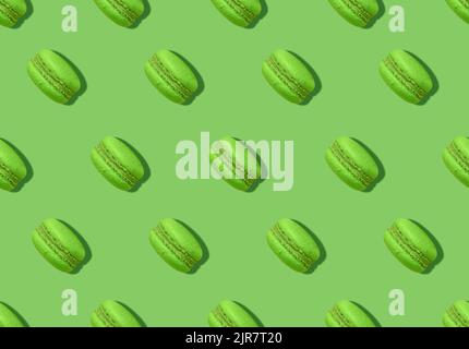 Macaroons. Pattern in minimal style. Pistachio french biscuits on bright green backdrop Stock Photo