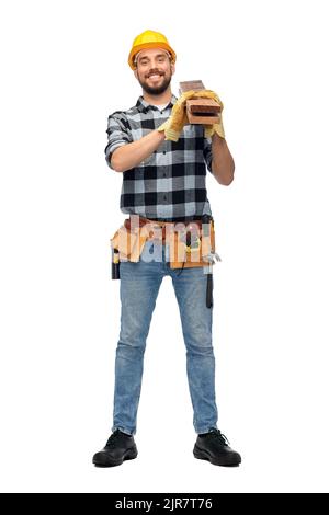 happy male worker or builder in helmet with boards Stock Photo