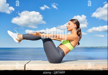 young woman exercising on sea promenade Stock Photo