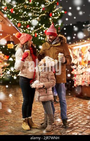 family with takeaway drinks at christmas market Stock Photo