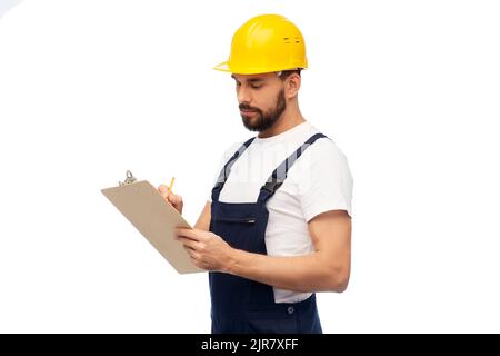 male worker or builder in helmet with clipboard Stock Photo