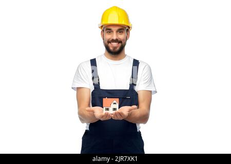 happy male builder holding model of living house Stock Photo