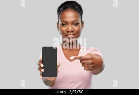 happy african american woman showing smartphone Stock Photo