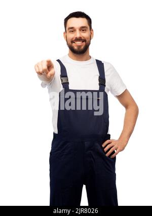 smiling male worker or builder pointing to camera Stock Photo