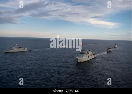 Royal Canadian Navy HMCS Margaret Brooke and Royal Danish Navy HDMS Triton lead the respective sides of a naval convoy for a photo exercise (PHOTOEX) in the Northern Atlantic Ocean, Aug. 6, 2022. USCGC Bear (WMEC 901) was one of many multi-national vessels that were also in this formation. (U.S. Coast Guard photo by Petty Officer 3rd Class Matthew Abban) Stock Photo