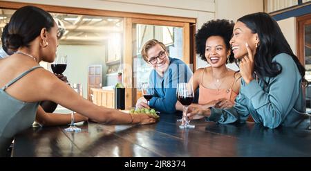Social friends drinking wine, relaxing and talking together in a restaurant for fun, reunion and happy bonding. Diversity of smile people enjoying Stock Photo