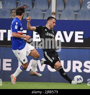 Genova, Italy. 22nd Aug, 2022. FC Juventus' Filip Kostic (R) shoots during an Italian Serie A football match between FC Juventus and Sampdoria in Genova, Italy, Aug. 22, 2022. Credit: Federico Tardito/Xinhua/Alamy Live News Stock Photo