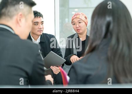 Business office colleagues having a meeting while sitting on the couch. Stock Photo