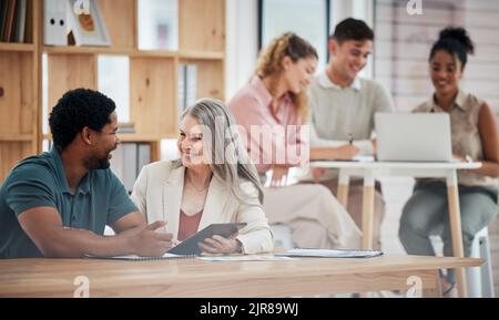 Digital marketing, planning and discussing strategy while diverse colleagues sit together to talk about growth development and innovation. Happy Stock Photo