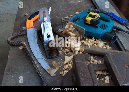 A set of tools useful in construction for woodworking like jigsaw - Saw - plane tool - mounting tool and meter on the metal working space Stock Photo