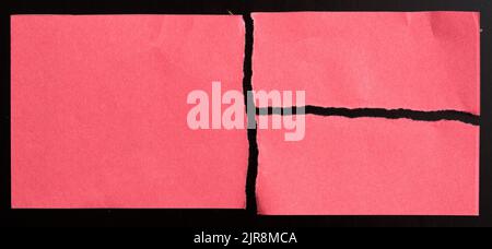 Red torn paper on black background Stock Photo
