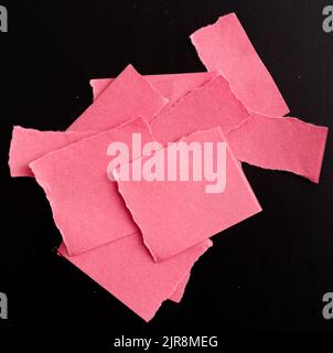 Red torn paper on black background Stock Photo