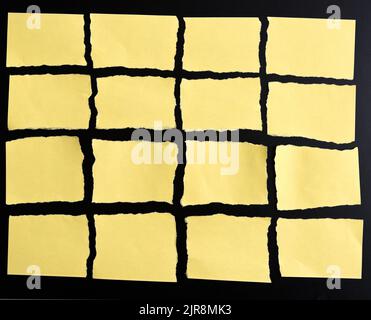 Torn yellow paper on black background Stock Photo