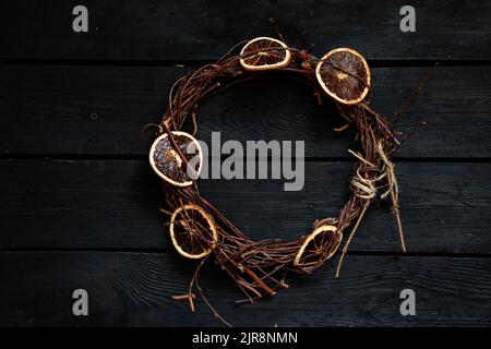 new year christmas wreath on an old wooden table, decor for the holiday, dry vine wreath Stock Photo
