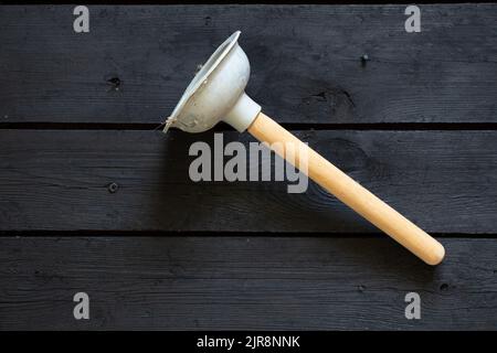 Plumber's drain cleaner tool. Rubber suction cup with wooden handle Stock  Photo - Alamy