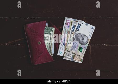 five hundred hryvnia bill lies in a red leather wallet on the table, Ukrainian hryvnia Stock Photo