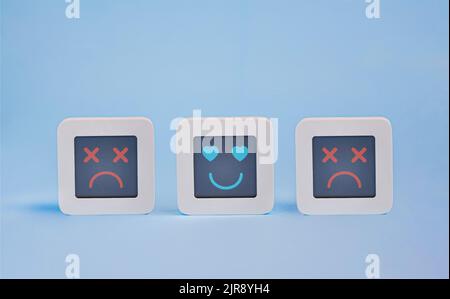 Set of computers with stylized faces of heart eyes and dead faces on lcd display, Customer Experience Concept, a system crash symbol Stock Photo