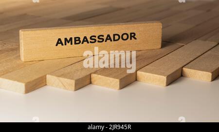 Ambassador written on wooden surface. Concept created from wooden sticks. Stock Photo