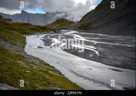 Lämmerenboden with meandering creek and wildstrubel glacier in the distance in valais Stock Photo