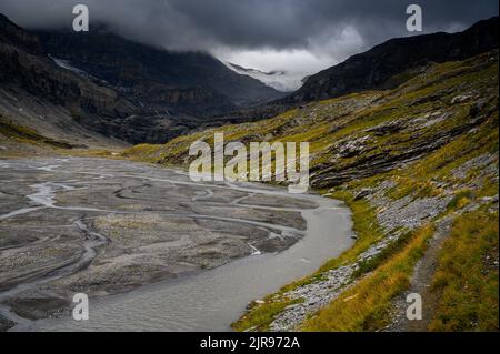 Lämmerenboden with meandering creek and wildstrubel glacier in the distance in valais Stock Photo