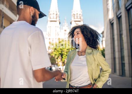 Young man giving aflowers to the young cute woman Stock Photo