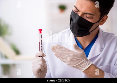 Young biochemist testing blood samples Stock Photo