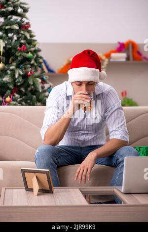 Young man celebrating New year at home alone Stock Photo