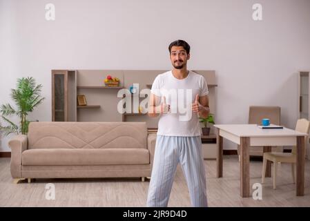 Young man doing sport exercises in the morning Stock Photo