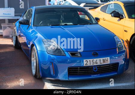 A blue Japanese Nissan 350Z sports car parked on the street Stock Photo ...