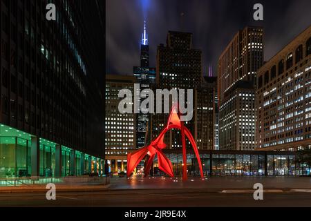 Chicago, Illinois / USA : October 13, 2018 Calder's Flamingo sculpture in the middle of the vibrant public place, Federal Plaza, in Chicago, enclosed