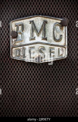 BMC diesel badge on front of vintage blue Nuffield tractor. Stock Photo