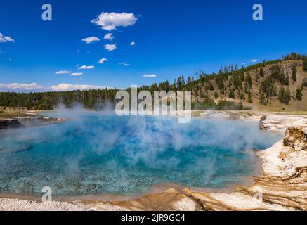 Steam rises off Excelsior Geyser Crater, a dormant fountain-type geyser in the Midway Geyser Basin of  of Yellowstone National Park, Wyoming, USA. Stock Photo