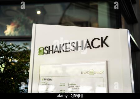 Singapore - July 21, 2022: Logo of Shake Shack, an American restaurant chain, in front of the restaurant.