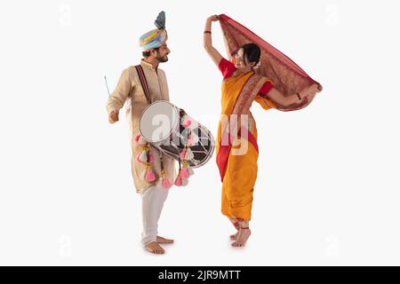 Portrait of Maharashtrian couple playing drum and dancing Stock Photo