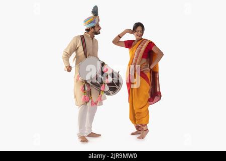 Portrait of Maharashtrian couple playing drum and dancing Stock Photo