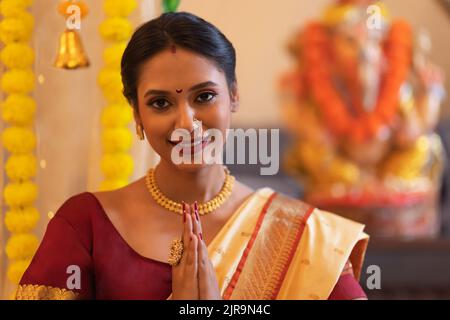 Close-up portrait of a cheerful Maharashtrian woman greeting on the occasion of Ganesh Chaturthi Stock Photo